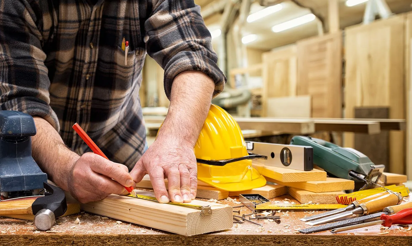 Preferred Remodeling carpenter cutting trim on a Smithtown, NY home remodeling job site.