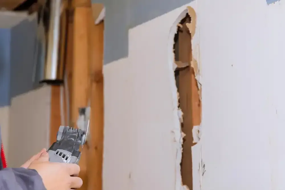 Repairing damaged plaster and wall surface inside an older Huntington, NY home during remodeling.