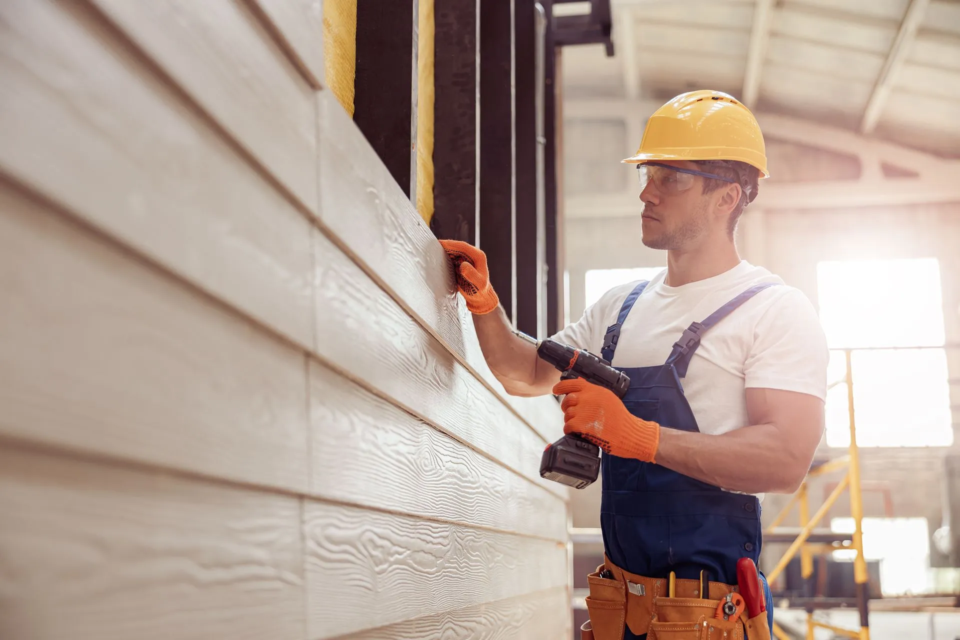 Carpenter installing exterior wood siding on a Babylon, NY home remodeling project.